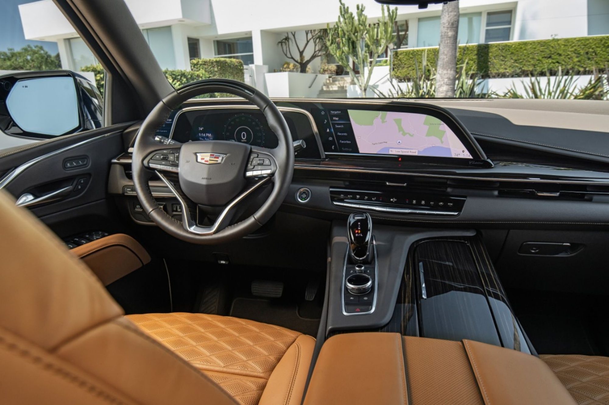 Curved OLED display, steering wheel and quilted tan seats of the 2021 Cadillac Escalade