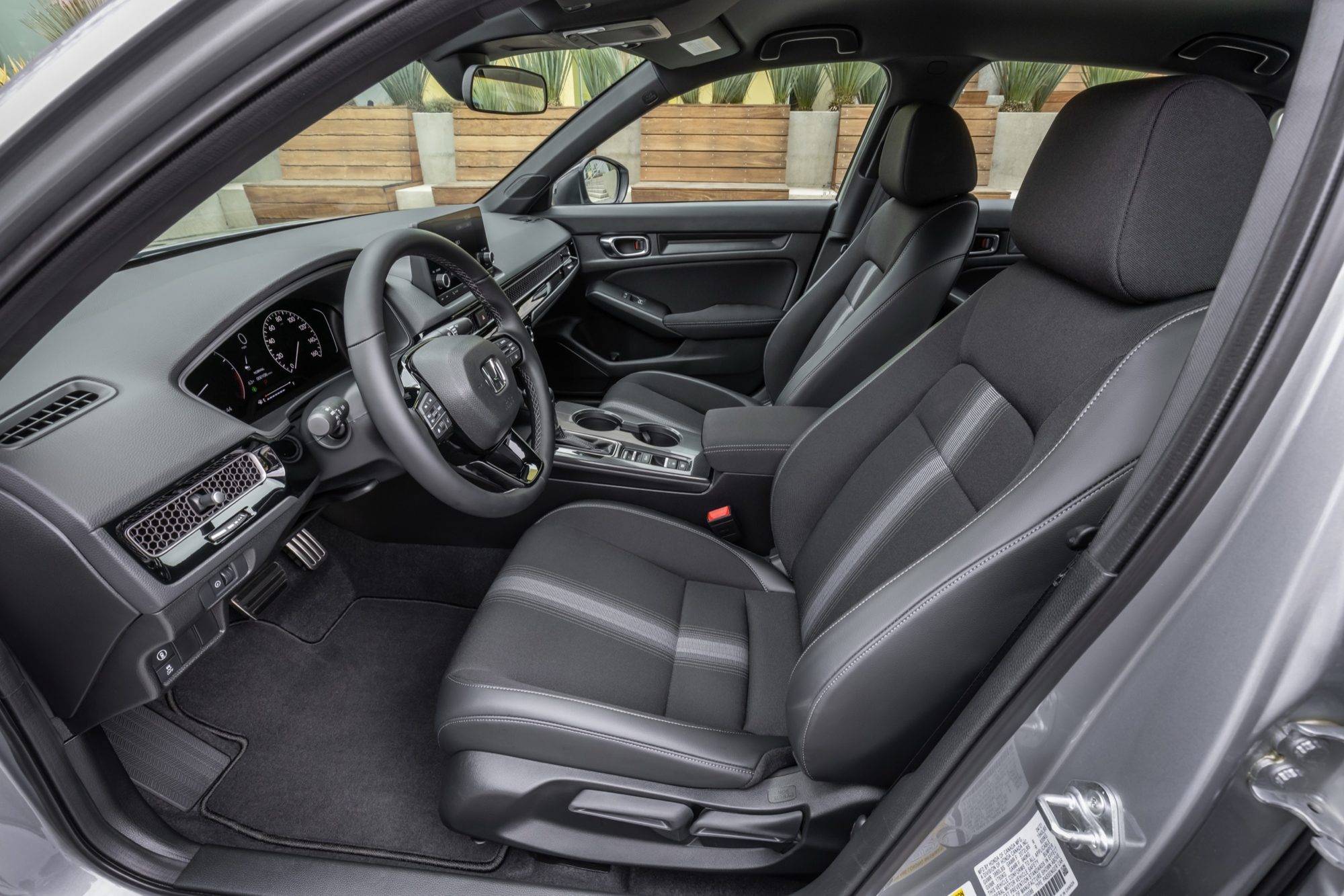 Black cloth front seats and dashboard of the 2022 Honda Civic Sport sedan