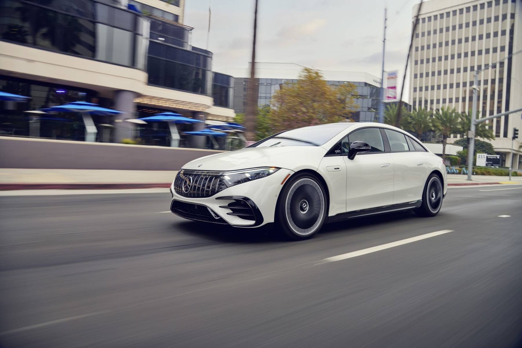 White 2022 Mercedes-AMG EQS driving on a California city street