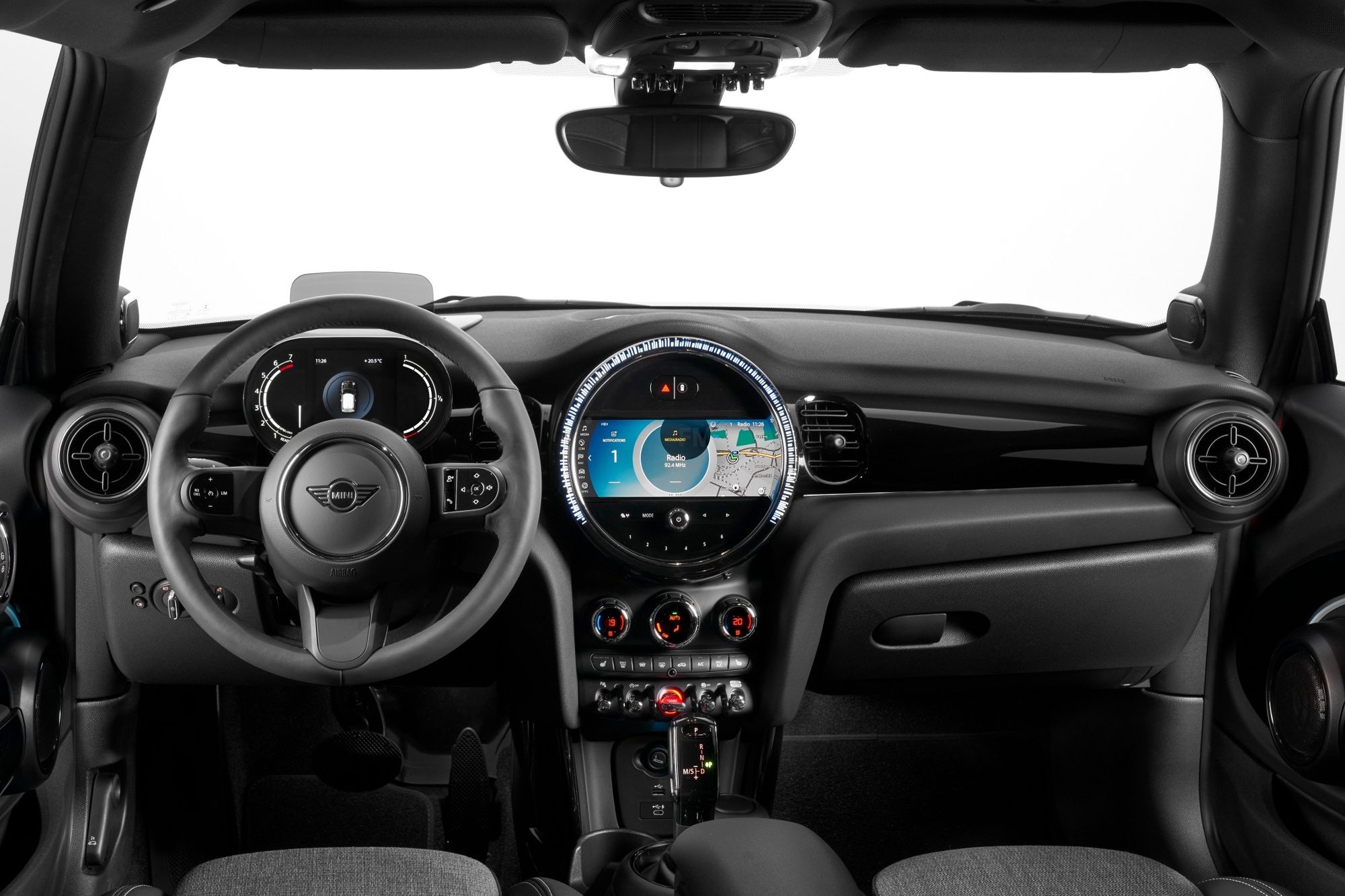 Dashboard of the 2022 Mini Cooper hardtop with its round center display and toggle switches
