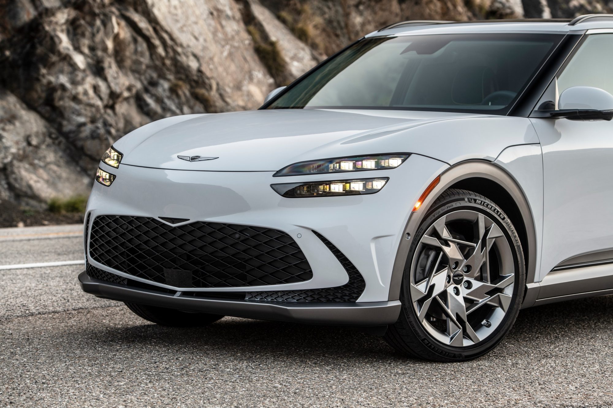 Front three-quarter view of a white 2023 Genesis GV60 with 21-inch wheels