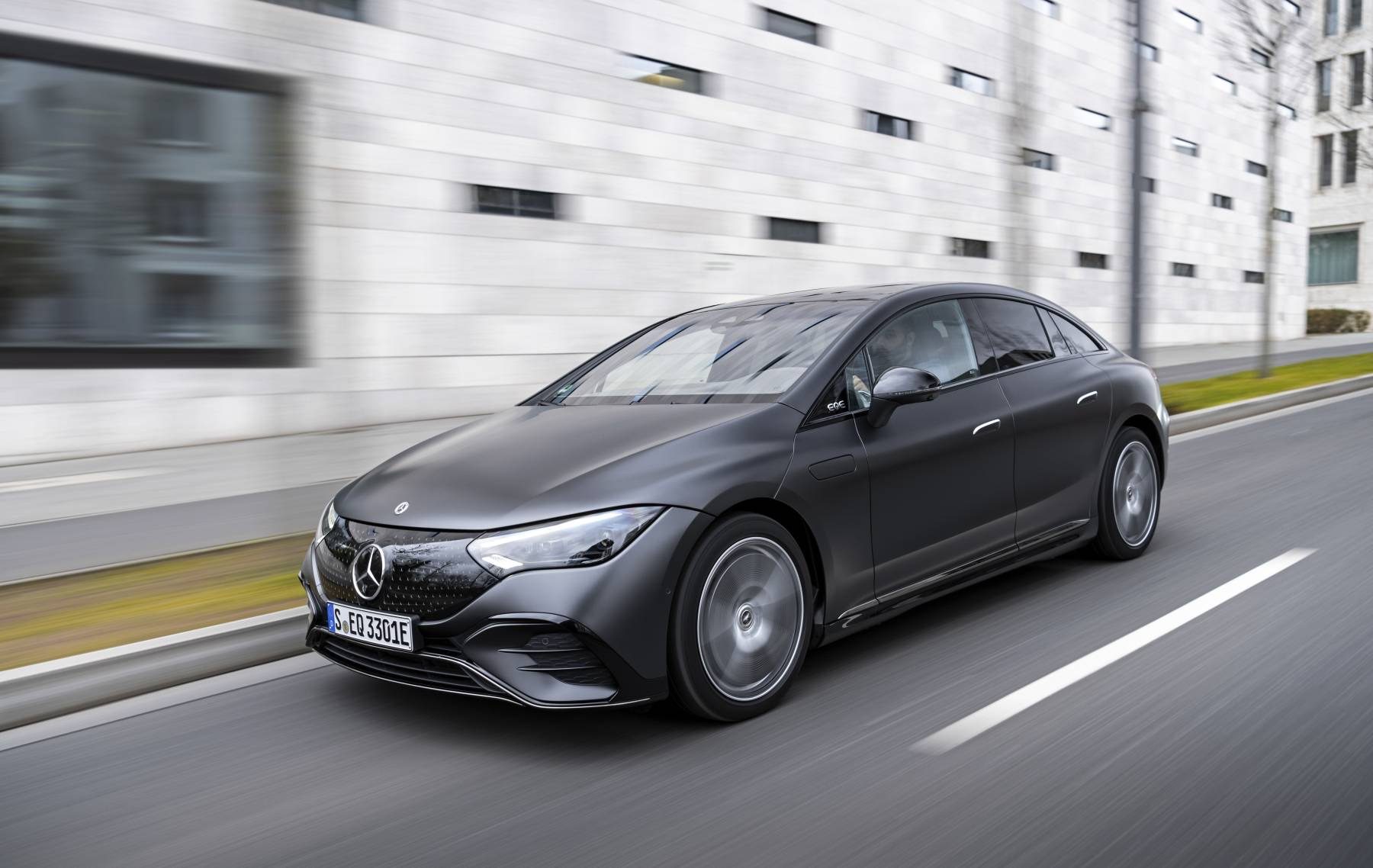 Matte grey 2023 Mercedes-Benz EQE 500 4MATIC driving on a city street