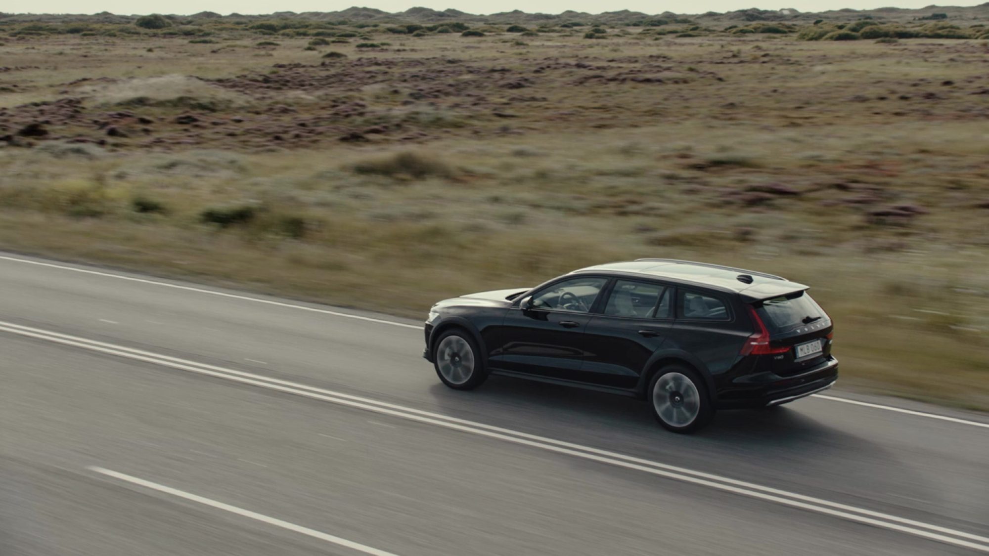 2023 Volvo V60 Cross Country B5 AWD in Onyx Black driving on a coastal road