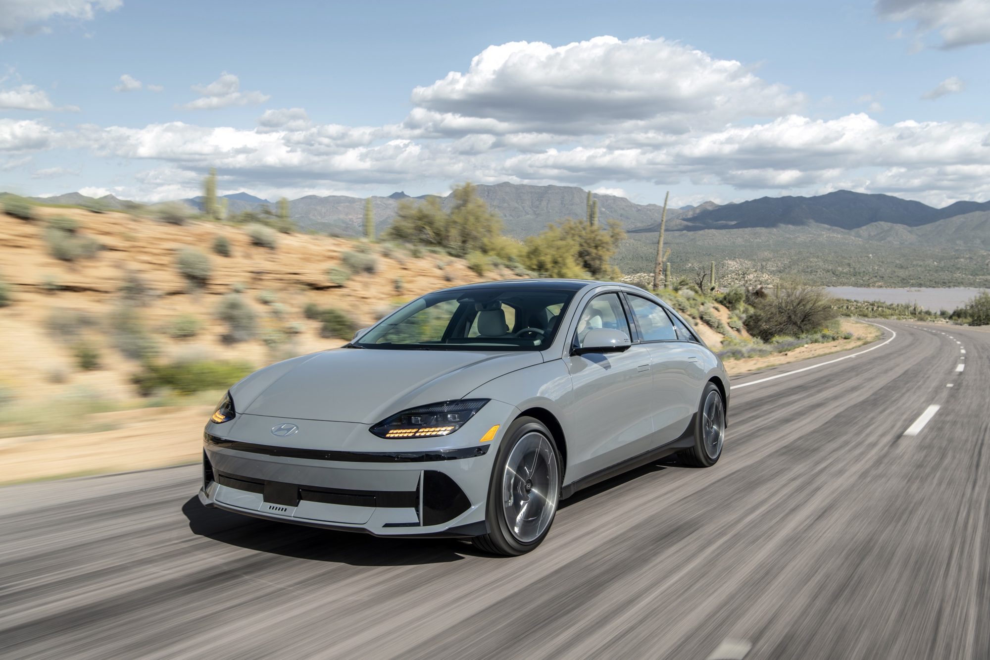 Gray 2024 Hyundai Ioniq 6 Limited driving on a desert highway