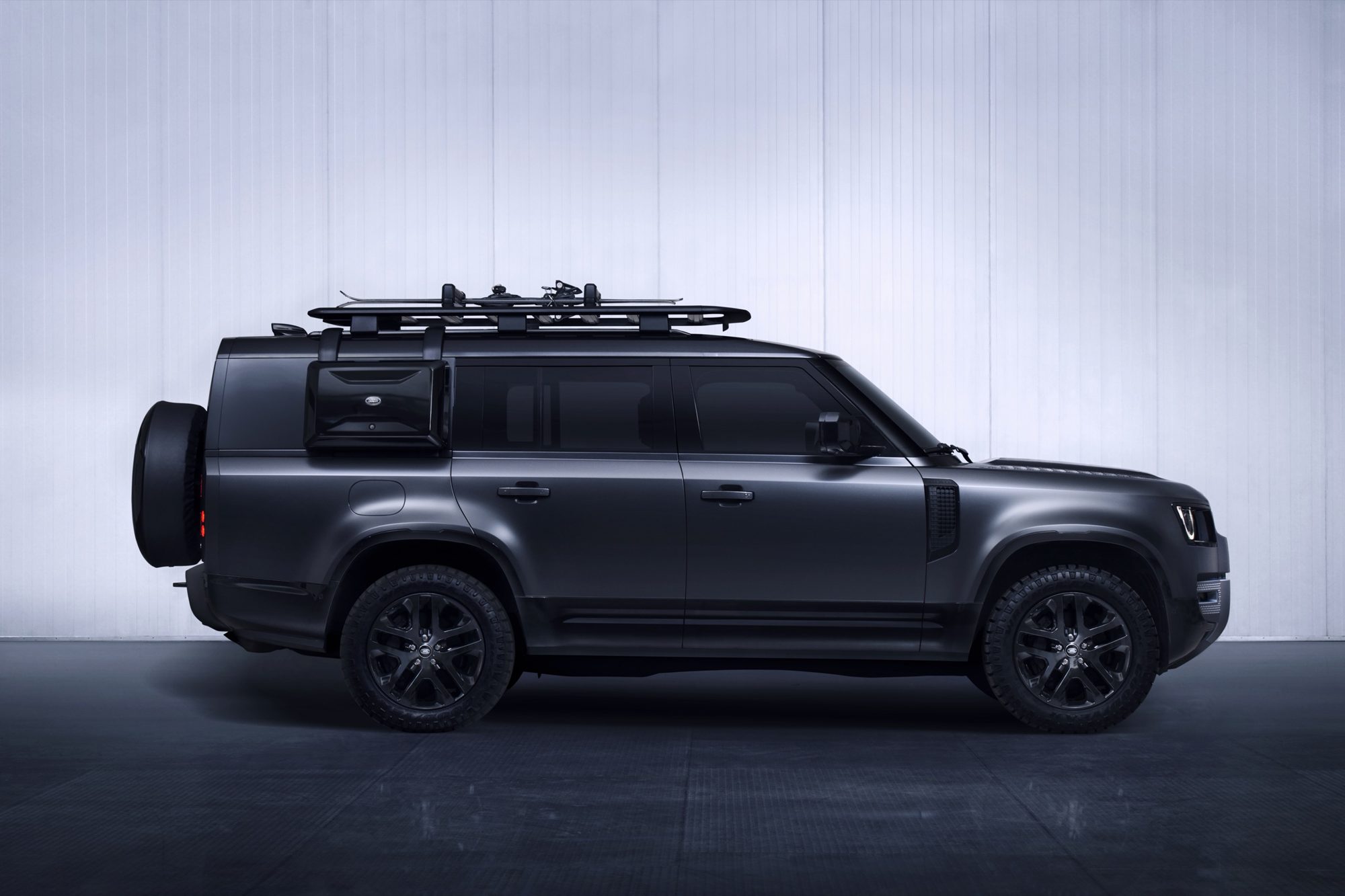 Side profile of the 2024 Land Rover Defender 130 Outbound with side-mounted gear carrier