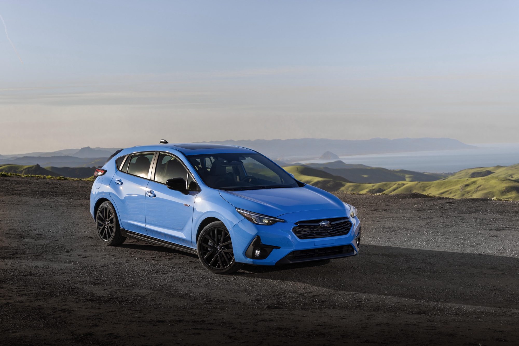 2024 Subaru Impreza Review: Does value right 1 Front three-quarter view of a blue 2024 Subaru Impreza RS hatchback