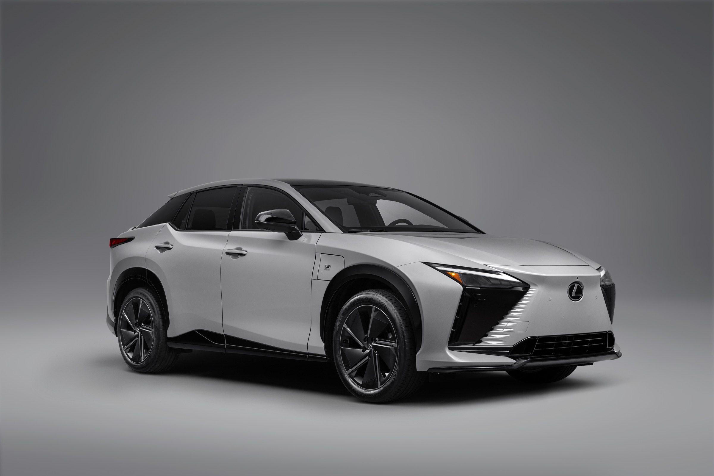 Silver 2026 Lexus RZ 550e F Sport front three-quarter view in a gray studio