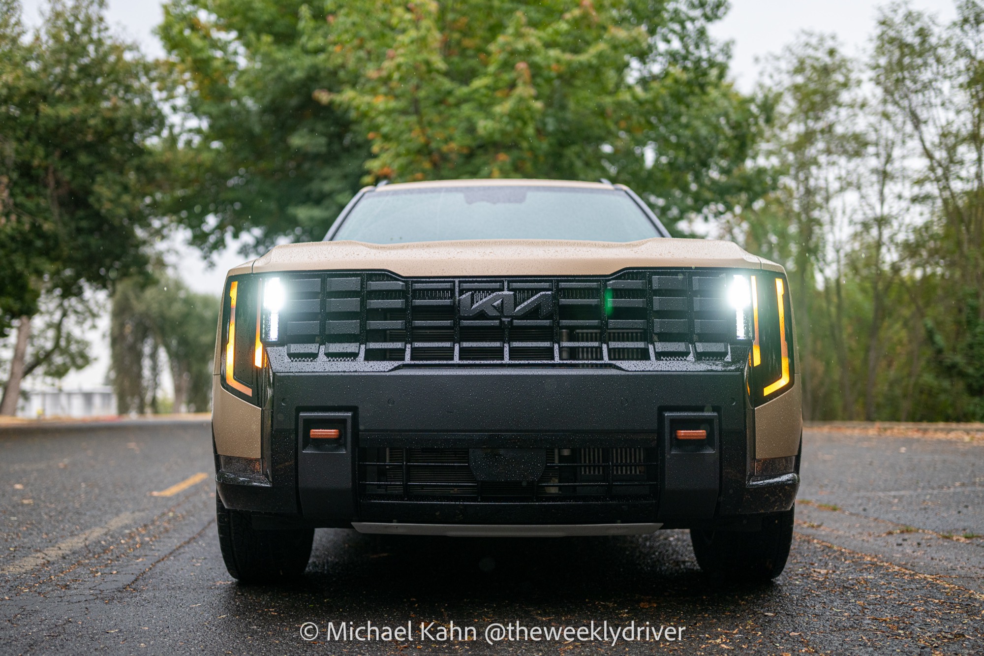 2027 Kia Telluride X-Pro rear three-quarter view showing X-Pro badge, black Telluride lettering and orange rear recovery hook