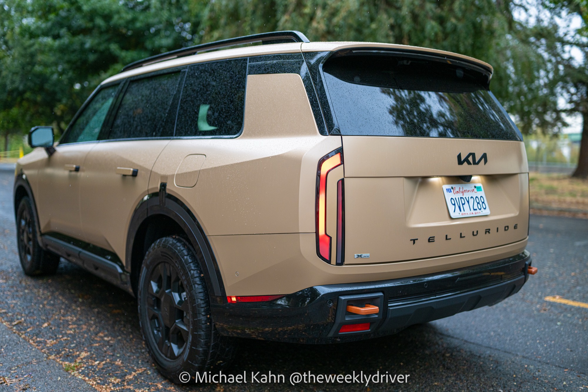 2027 Kia Telluride X-Pro side profile in Terrain Brown Matte showing flush door handles and black 18-inch wheels