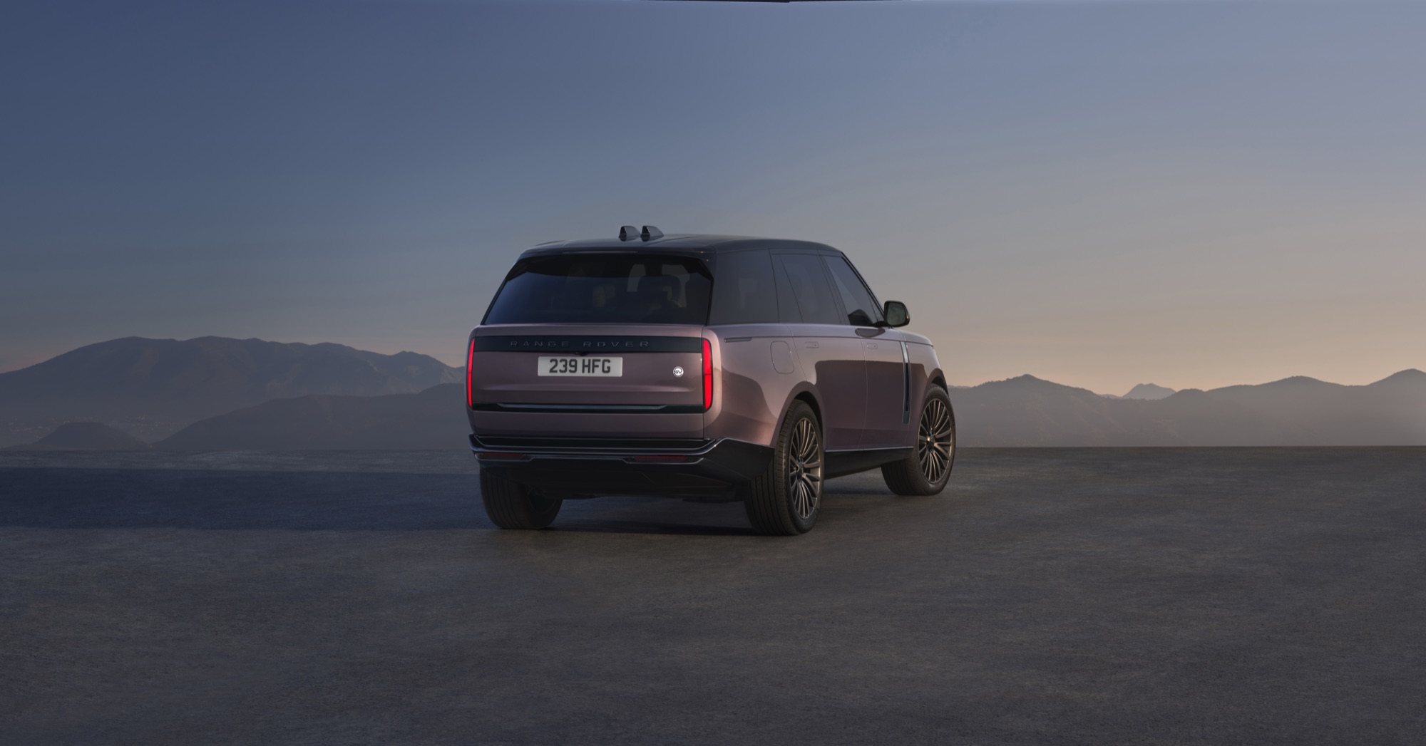 Range Rover Electric Starts at $138,000, the Same Price as the V8 SE 7 Range Rover Electric in a two-tone finish at dusk, rear three-quarter view