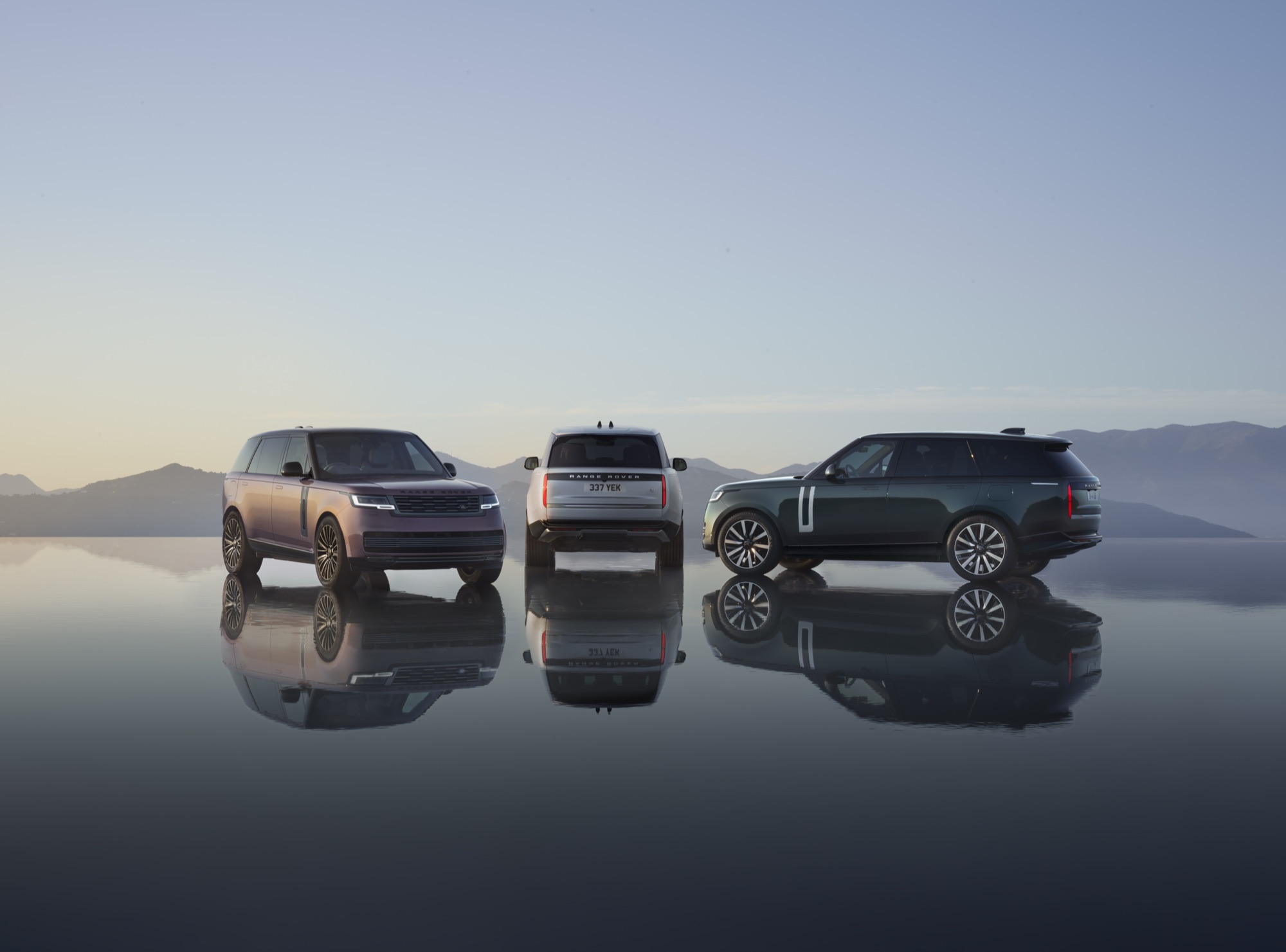Range Rover Electric Starts at $138,000, the Same Price as the V8 SE 4 Three Range Rover Electric models parked on a wet surface at dusk