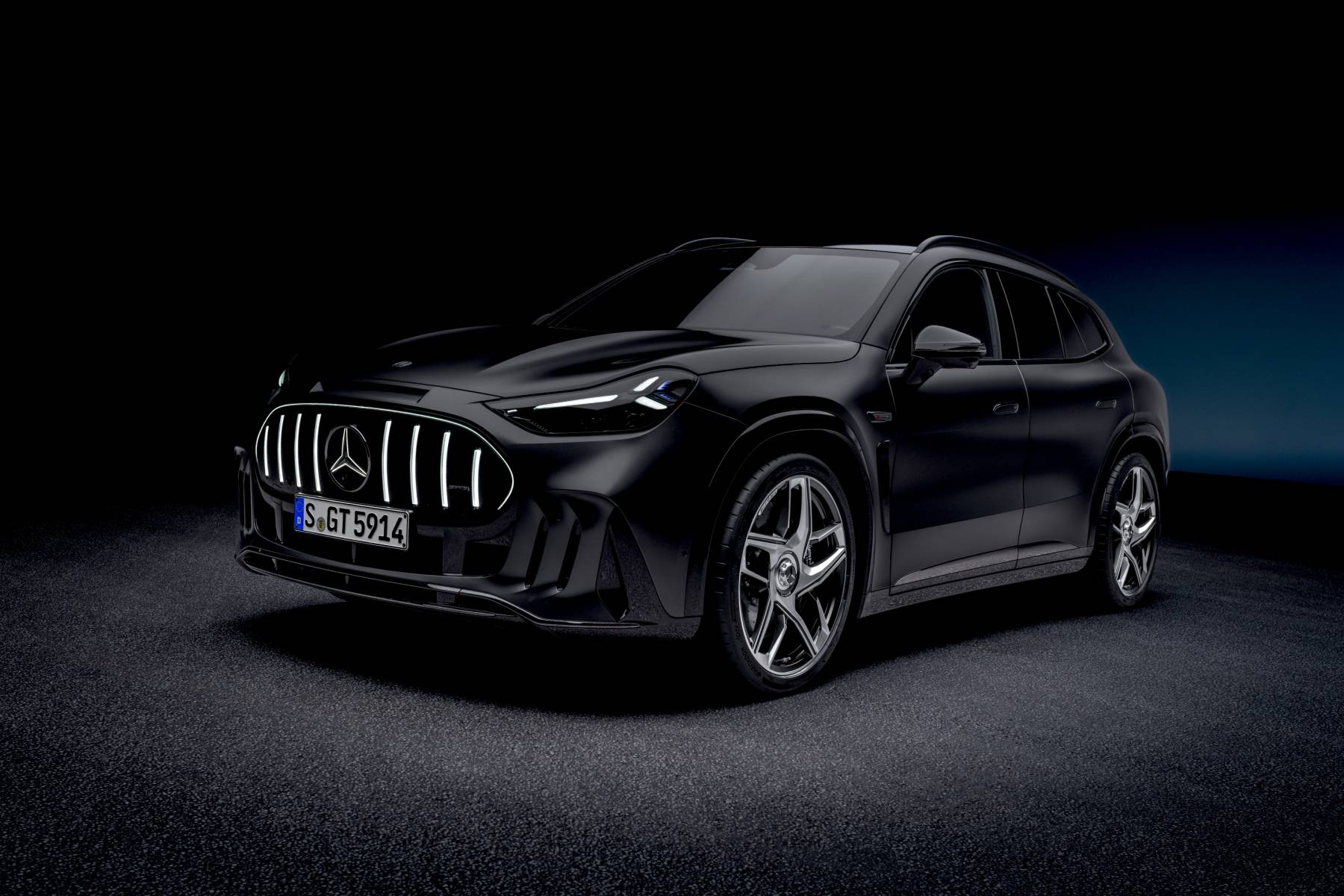 The 1,153-HP Mercedes-AMG GT SUV Plays Back a Recorded AMG V8 1 Black 2028 Mercedes-AMG GT SUV front three-quarter view in a dark studio with its lit vertical-bar grille