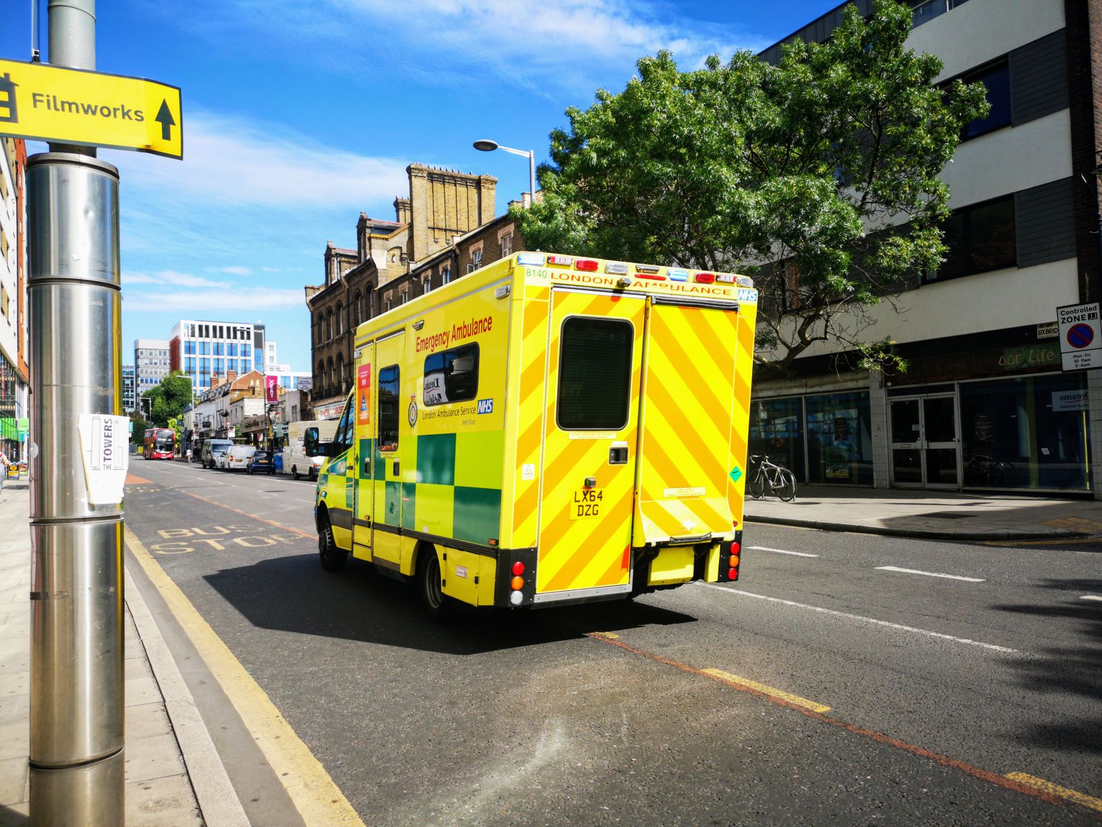 Emergency ambulance driving down a city street