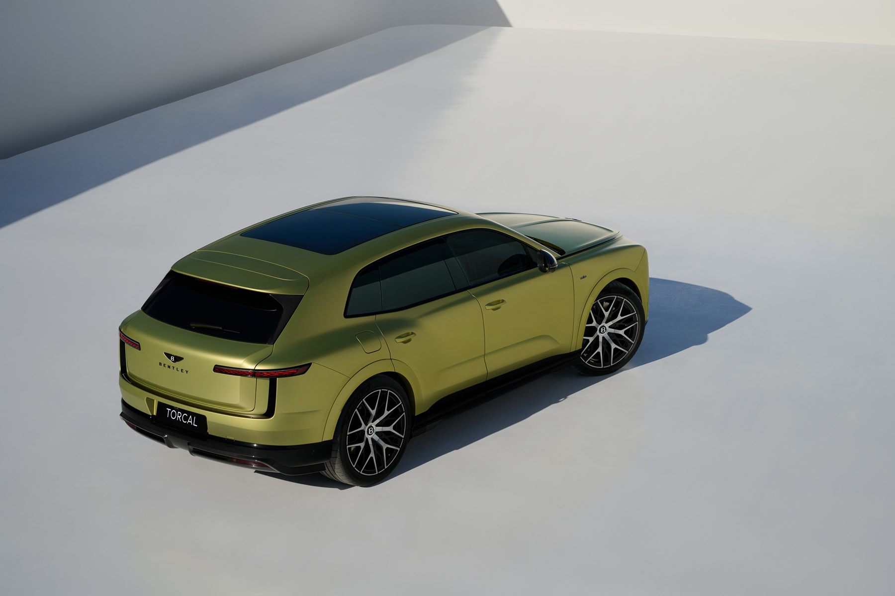 Green Bentley Torcal seen from above and behind in a studio, showing the tapering cabin and rear haunches