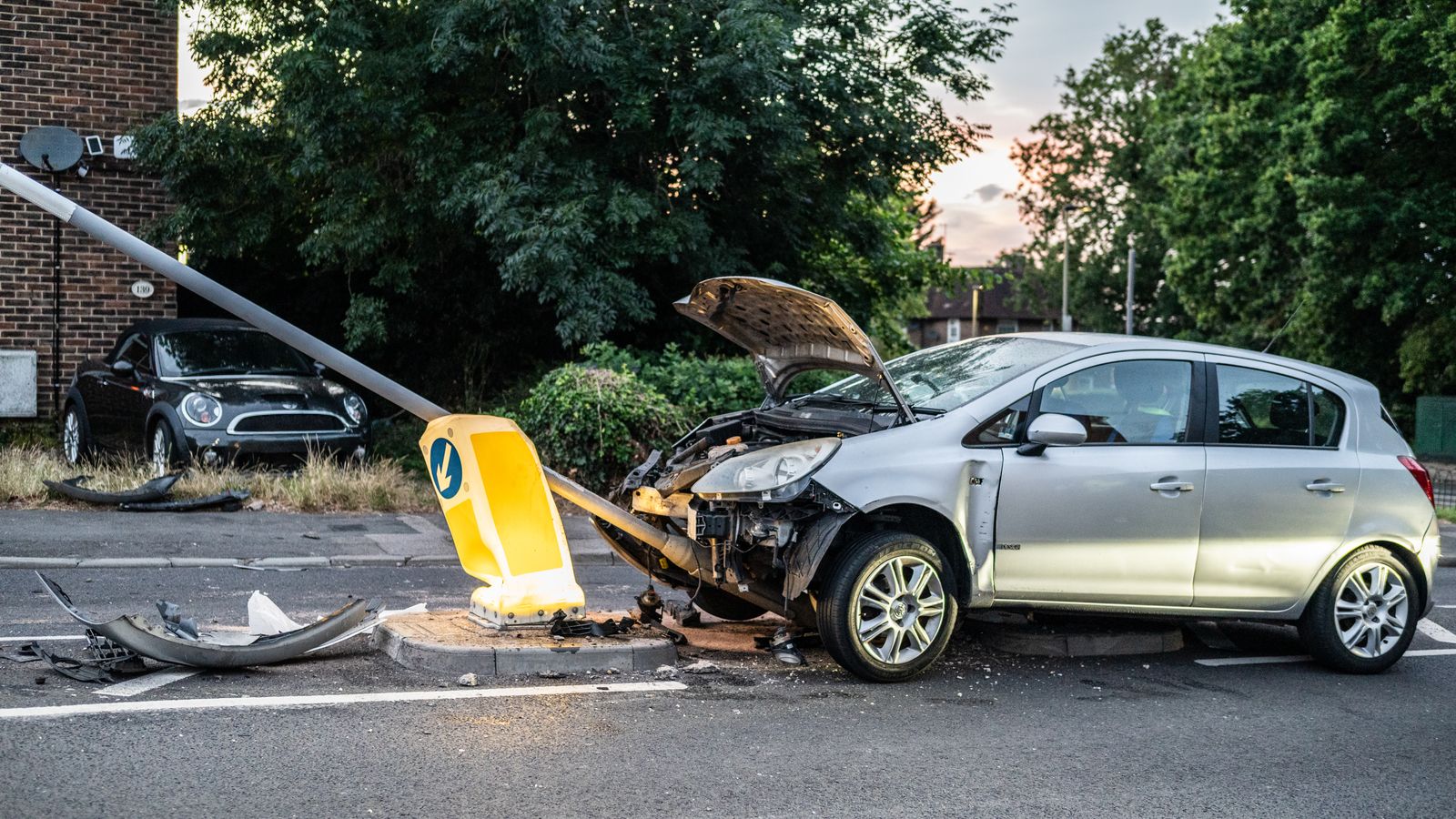 A Serious Car Wreck Can Trigger Hidden Costs for Injured Drivers 1 Silver hatchback with front-end damage after hitting a lamp post
