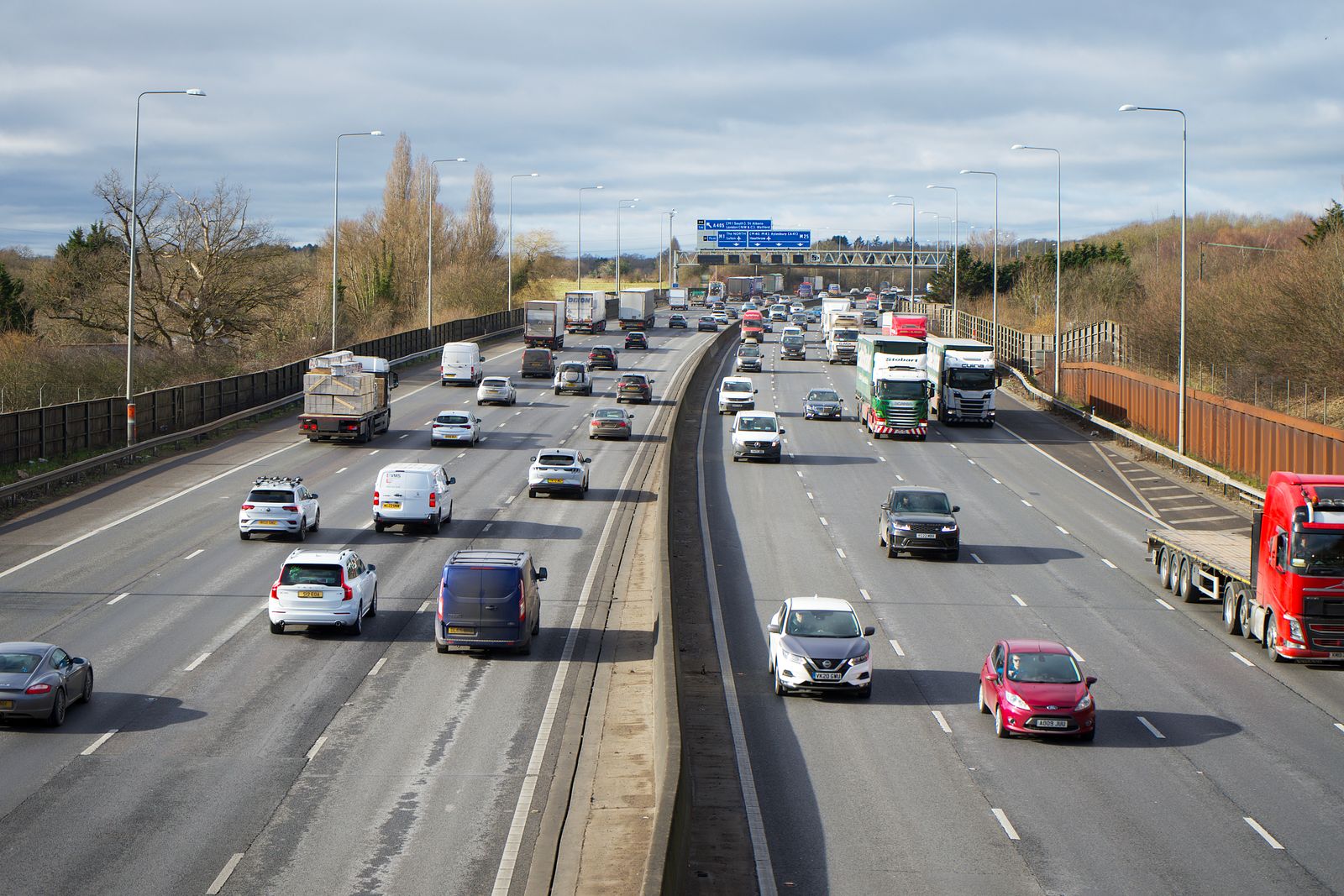 Cars and trucks traveling on a busy multi-lane highway