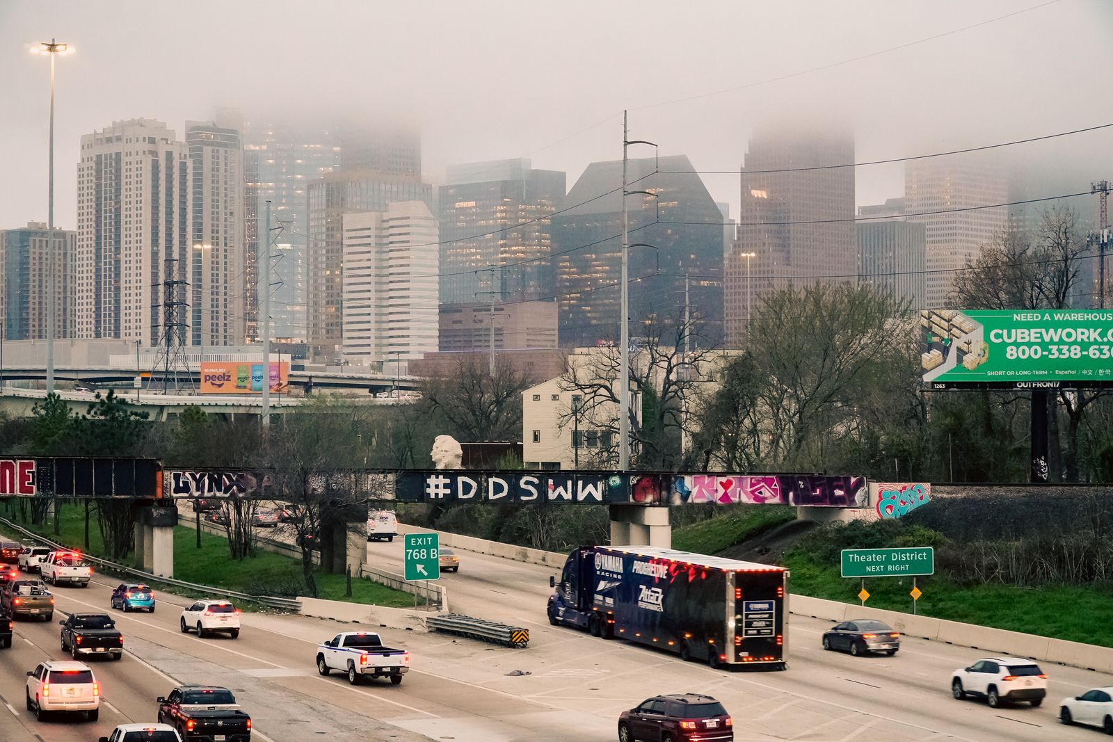 How to Strengthen a PTSD Disability Claim Before Submitting It 2 Morning freeway traffic below the fog-covered Houston skyline