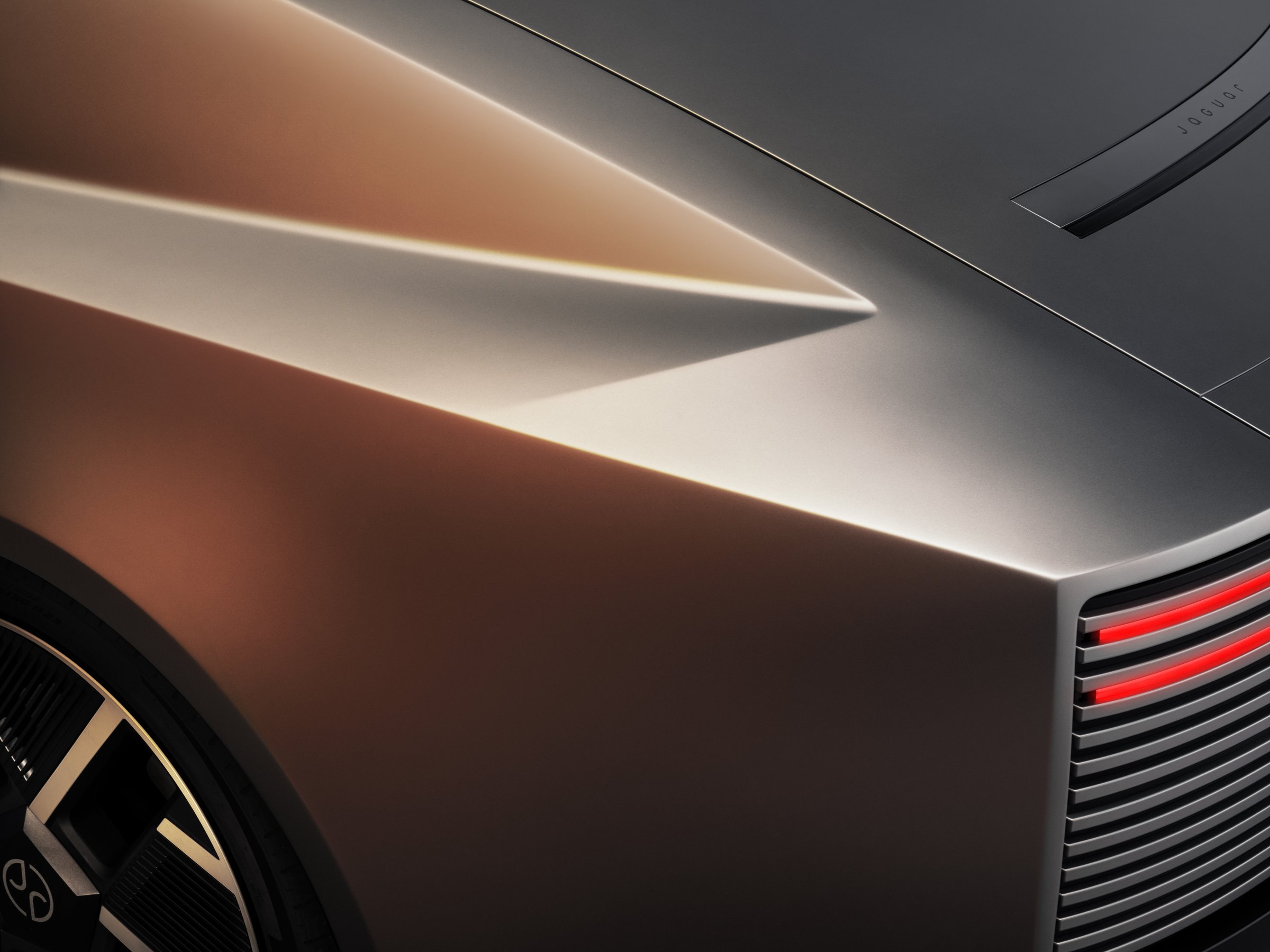 Close-up of the Jaguar Type 01 aluminum rear quarter panel curving into the horizontal-slat tail