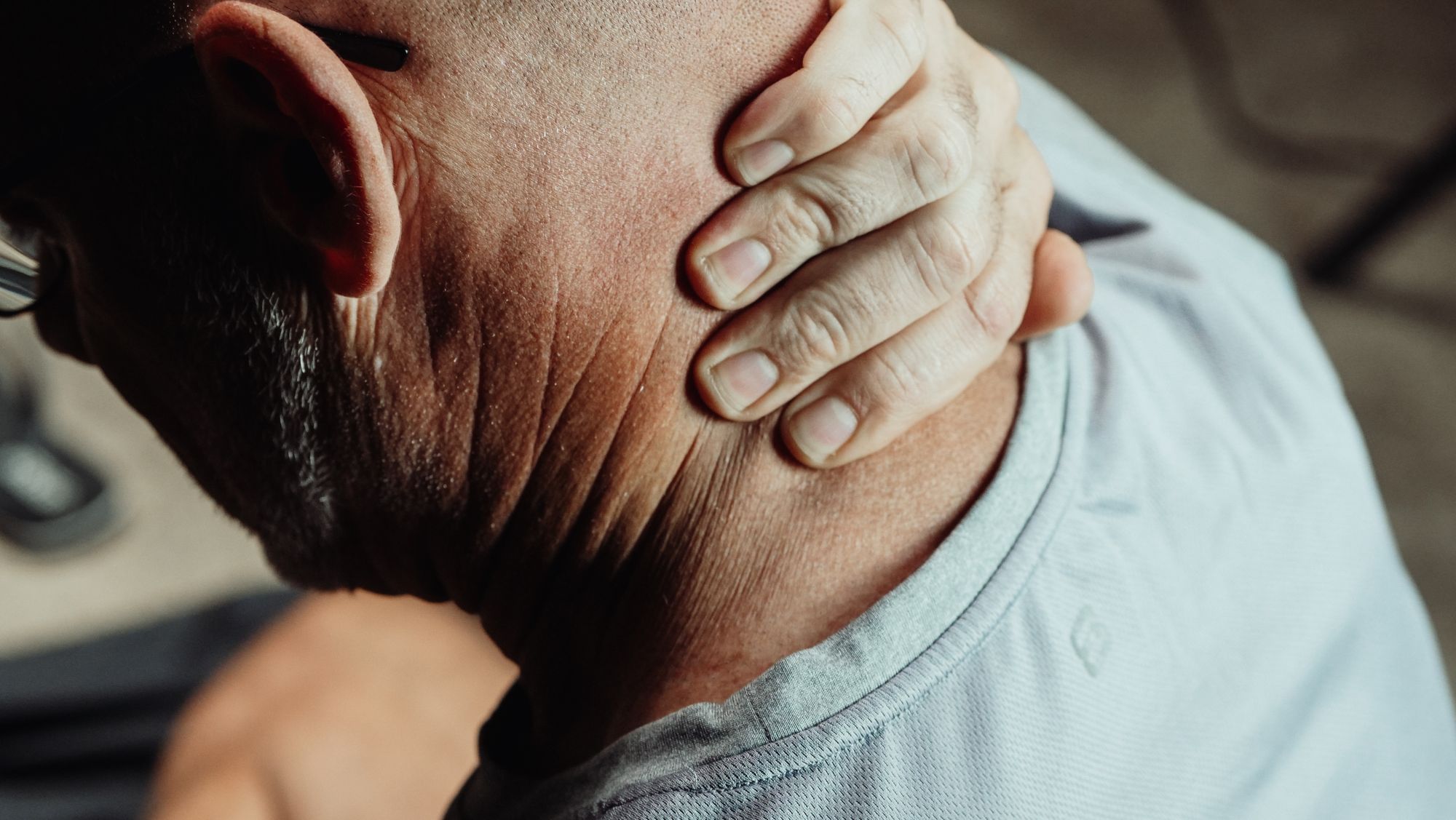 Aventura Car Accident Injuries That Show Up Days Later and Still Count 1 Man holding the back of his neck in pain
