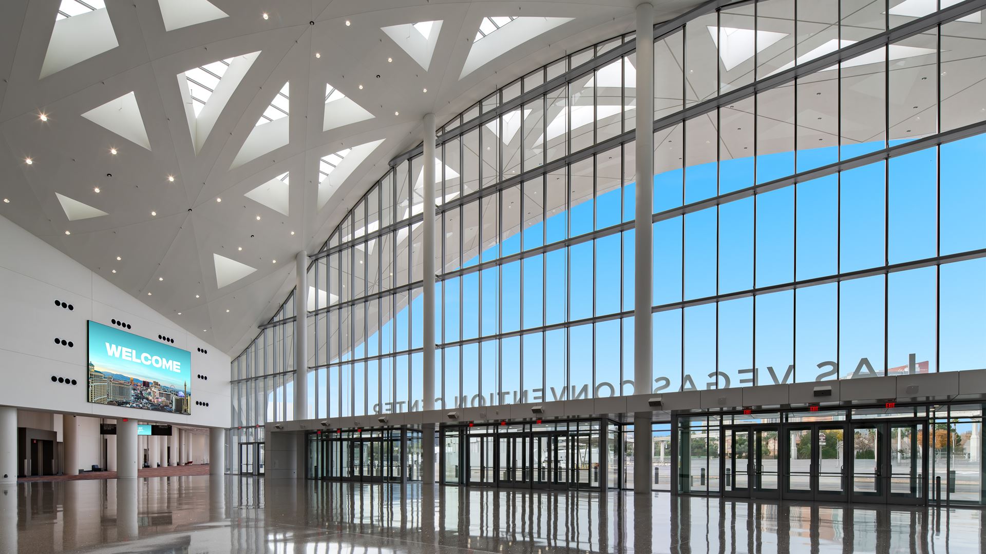 Glass curtain wall and skylit ceiling inside the new Grand Lobby at the Las Vegas Convention Center