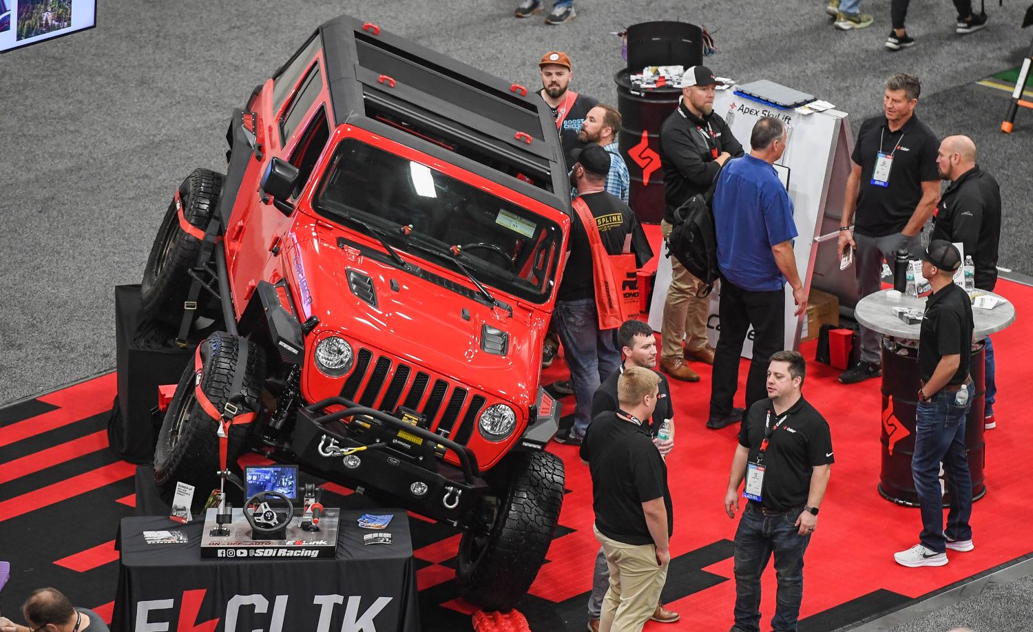 SEMA 2026: The Complete Guide to Dates, Friday Tickets, Halls and Automakers 6 A red Jeep displayed at a steep angle at a SEMA Show booth