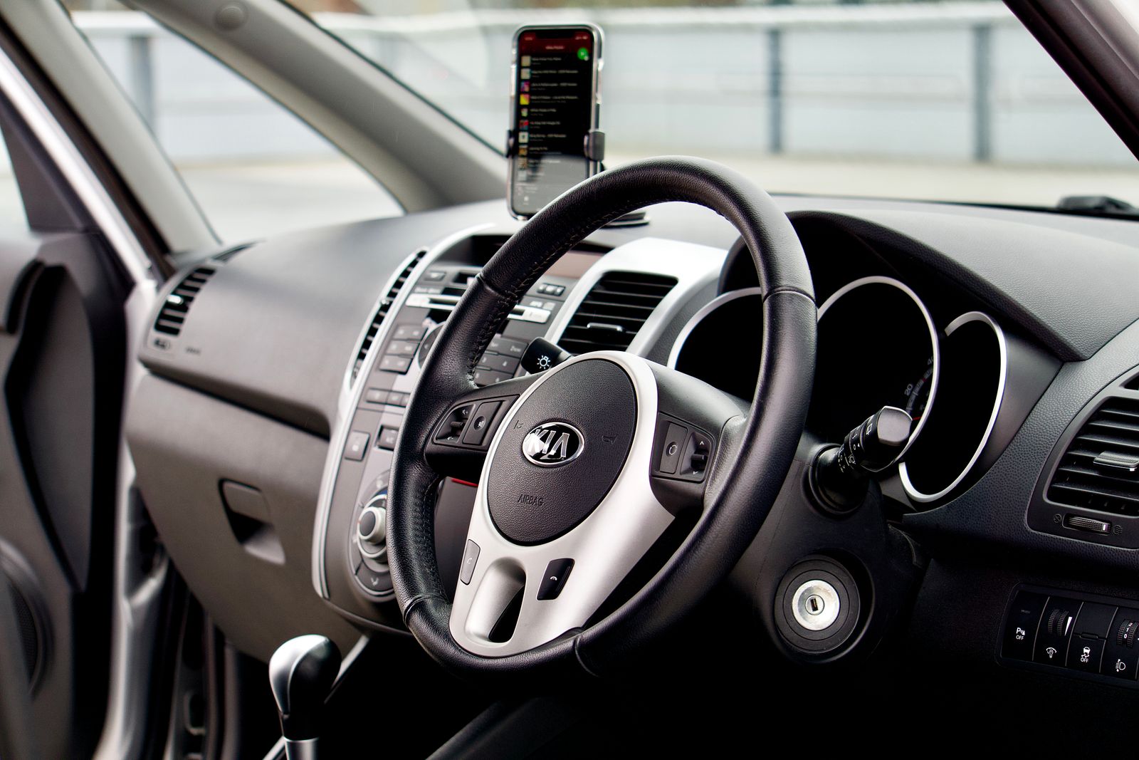 Steering wheel and dashboard with a phone in a windshield mount