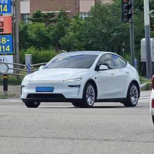White Tesla Model Y crossing an intersection in South Korea