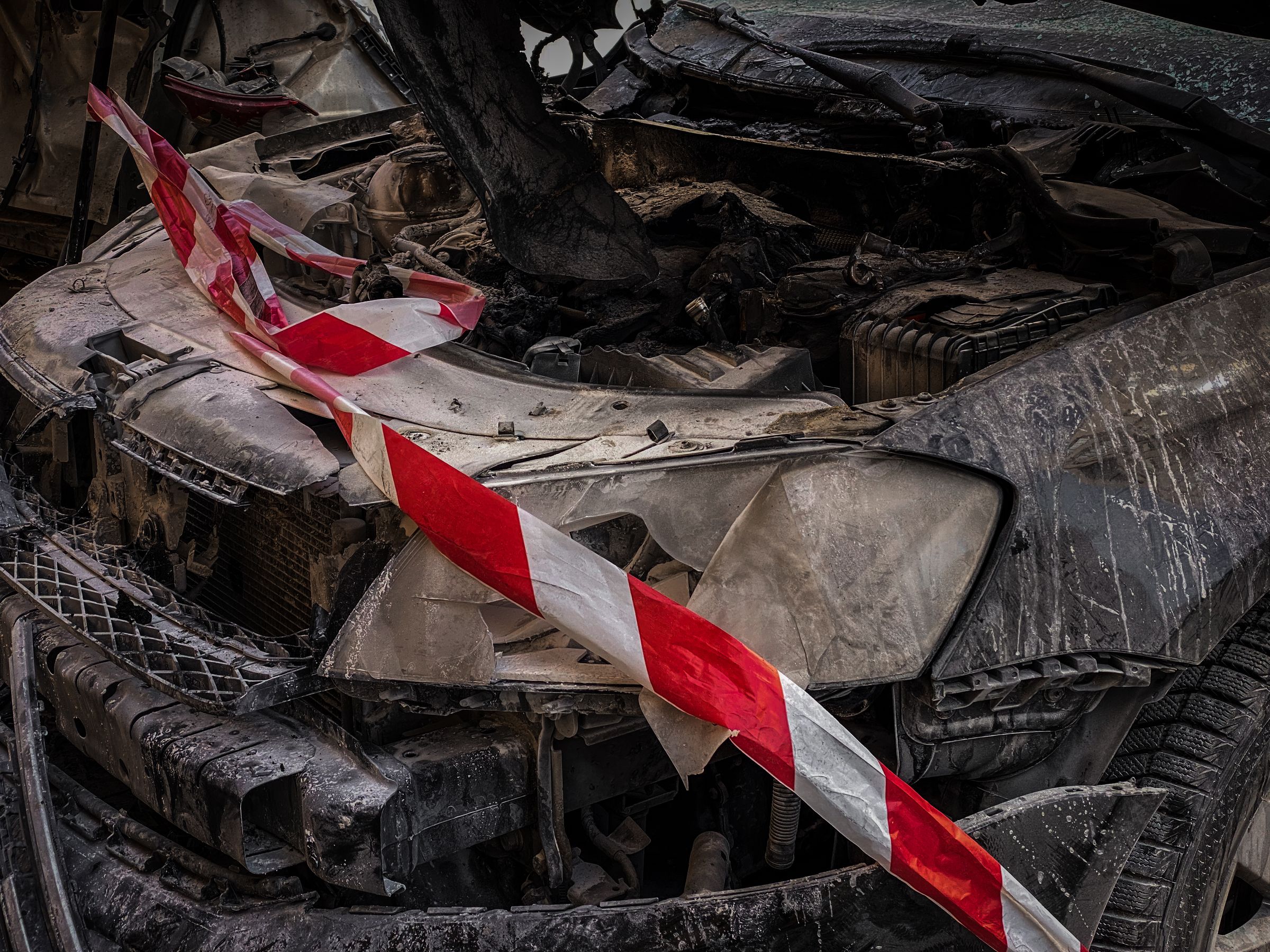 With New Car Prices Climbing, a Total Loss Payout May Not Be Enough to Replace Your Car 1 Front end of a wrecked car wrapped in red and white caution tape after a crash