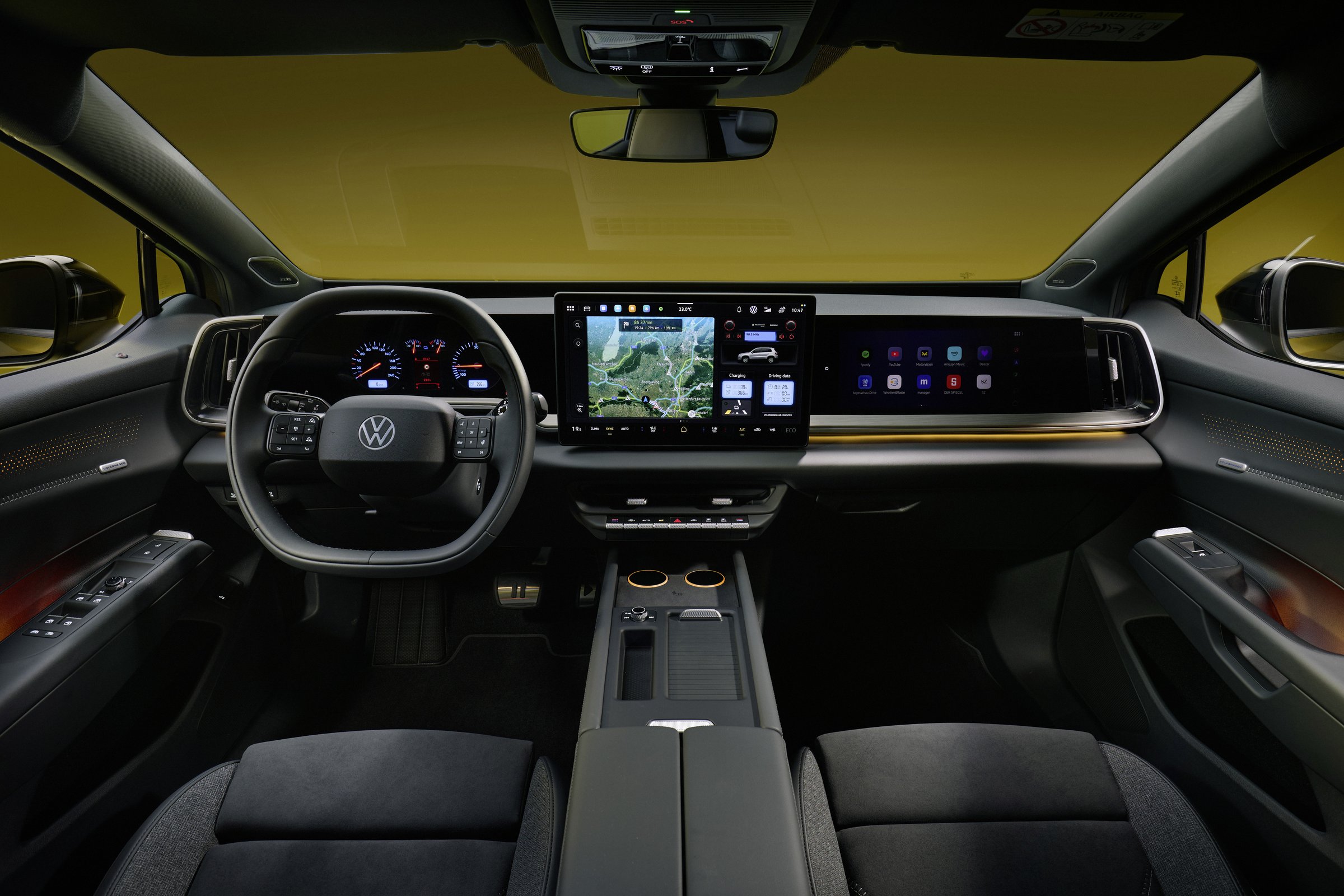 Volkswagen ID. Tiguan dashboard with a 15-inch center touchscreen, passenger display, round Golf IV-style gauges and a row of climate buttons below the screen