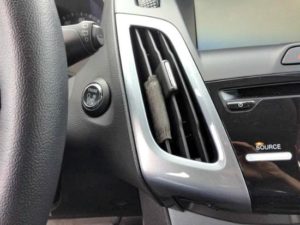 Perk Vent Wrap air freshener installed on vent of a 2014 Ford Focus.